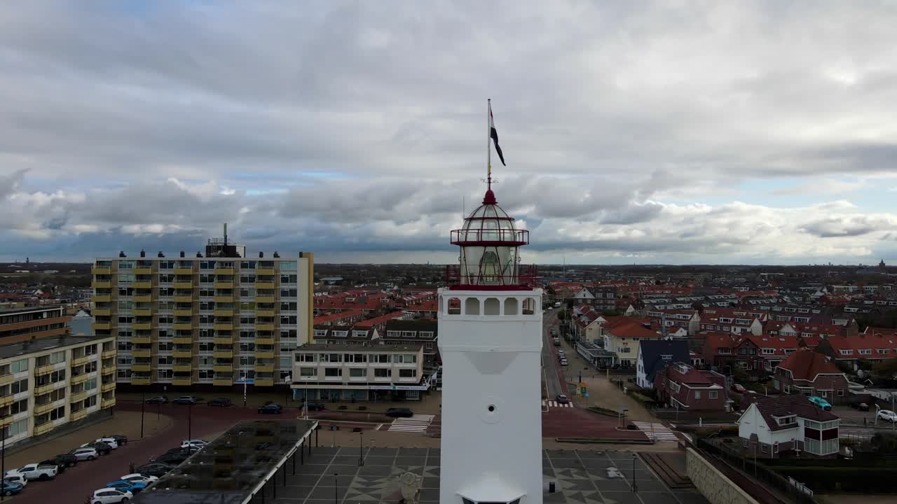 Revealing drone shot of a lighthouse near the coast of Scheveningen, the Netherlands