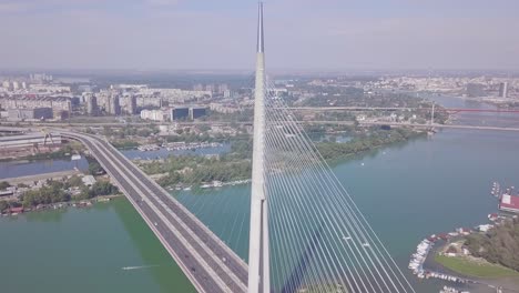 fantastic long 4k aerial orbiting shot of ada bridge in belgrade and city center