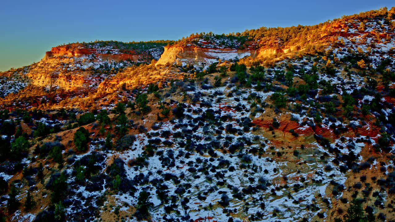Drone shot of the sun hitting the canyon walls at dawn