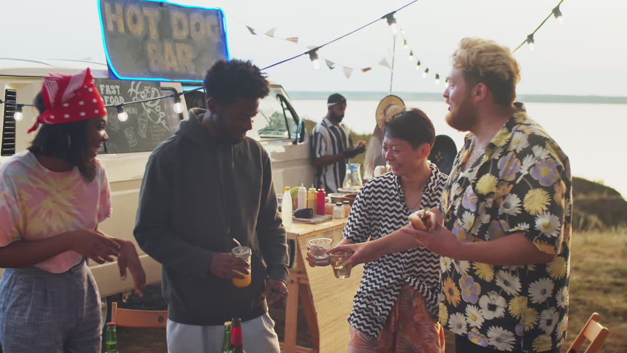 Cheerful Multiethnic Friends Chatting and Laughing at Summer Festival