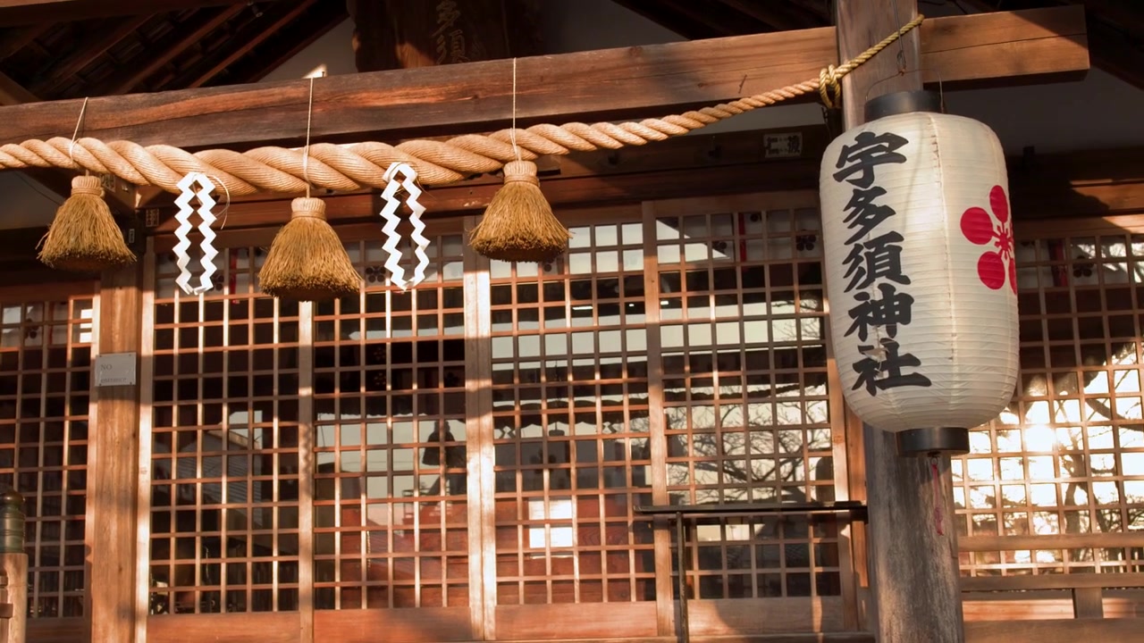 Panning Up a Traditional Japanese Temple with Shimenawa and Lantern