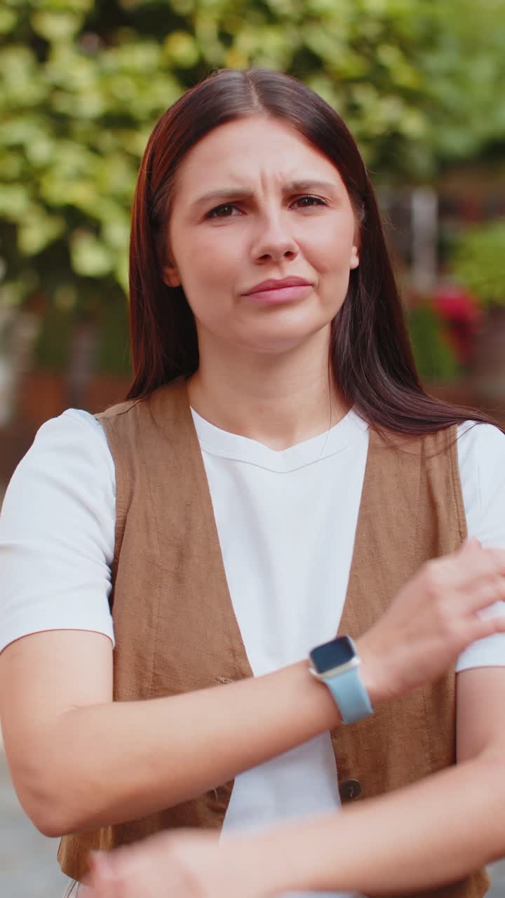 Upset caucasian woman reacting to unpleasant awful idea shaking finger at camera on city street