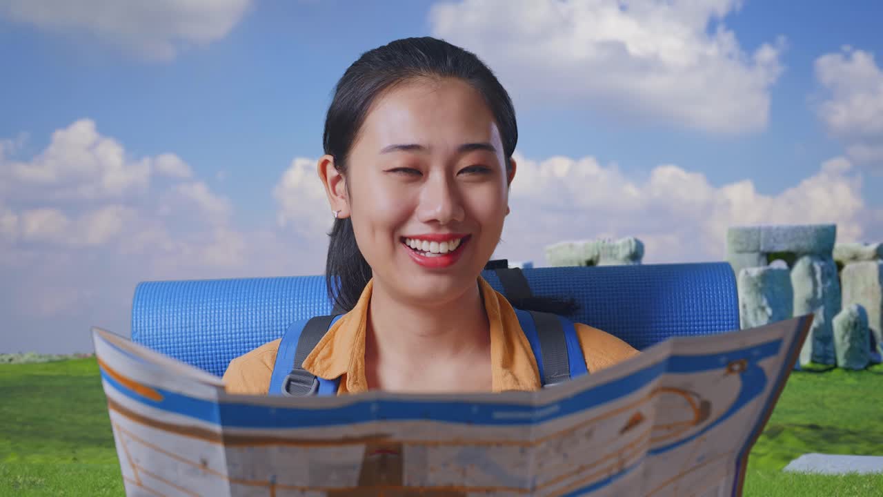 Close Up Of Asian Female Hiker With Mountaineering Backpack Looking At The Map Then Smiling To Camera While Traveling In Stonehenge
