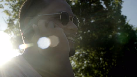 smiling man talking by smartphone