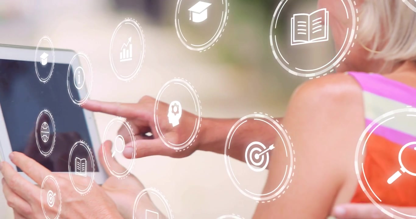 mature pair reaching forward holding tablet initiating joint tapping while learning icons floating