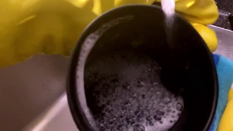 slow motion, kitchen work, sponging dishes, soapy foam, rinsing detergent