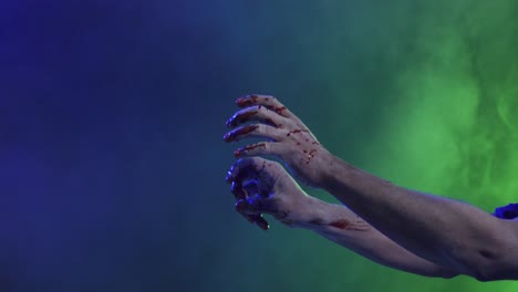 video of hands covered with blood moving over smoke on black background