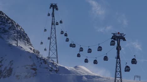 gondola lift bringing people up the mountain for skiing and snowboarding with a blizzard