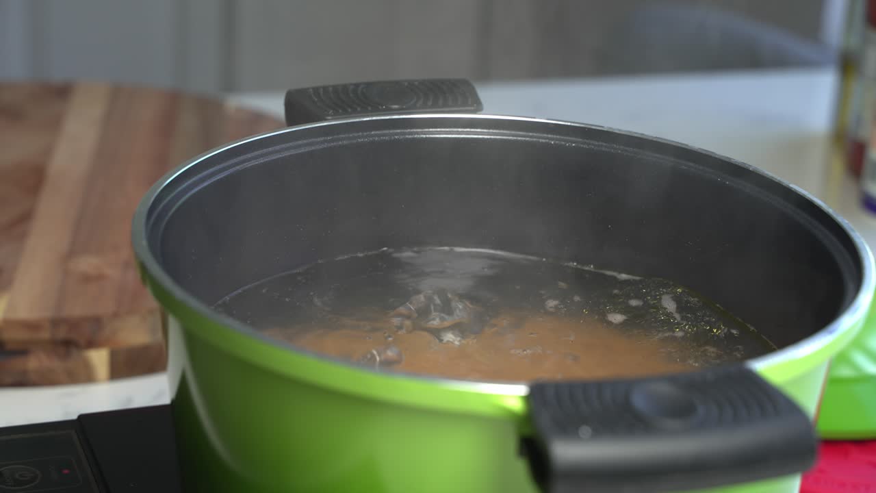 Pasta cooking in hot water with steam rising, homemade meal, cooking spaghetti, close up