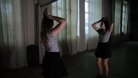 Teenage-girl-dancing-in-the-dark-studio-alone-slow-motion