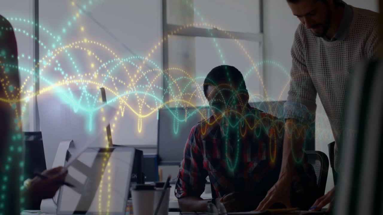 Tech team discussing designs over laptop, designer pointing layouts and neon waveforms showing data
