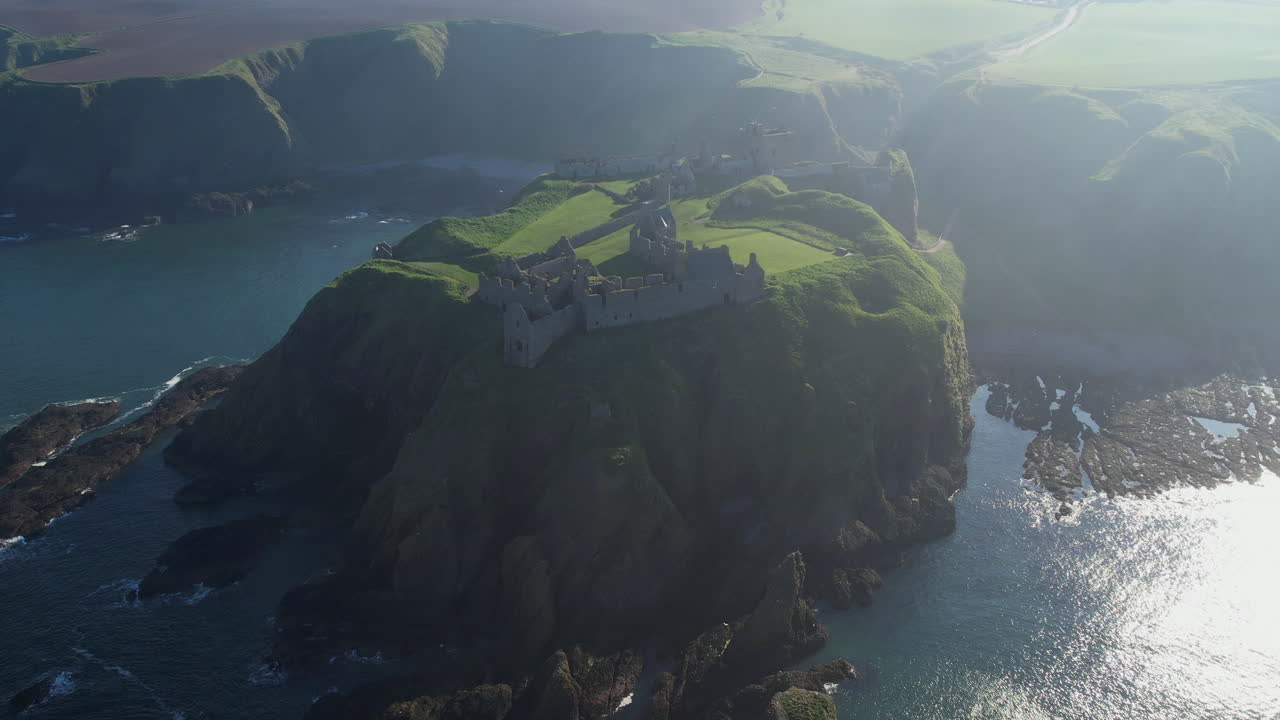 circular wide aerial  view  of the full rock in the sea with the ruins of dunnottar castle in the scottish stonehaven