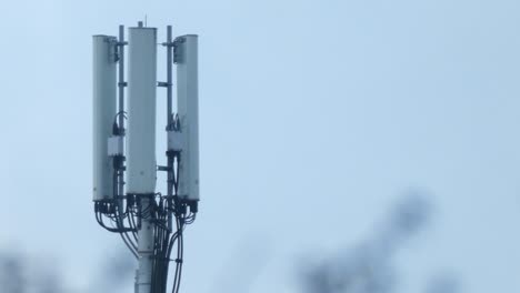 cellular telecommunication transmission tower on gloomy overcast morning static shot