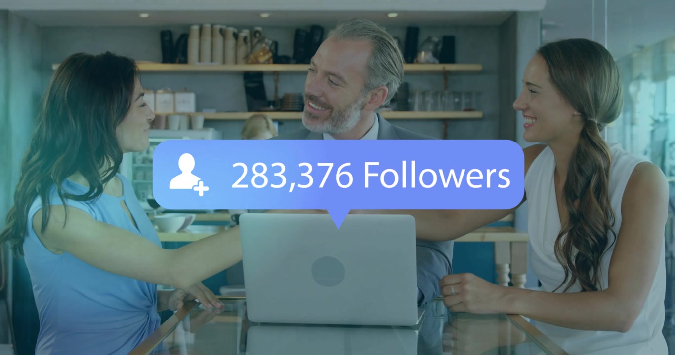 Three business colleagues at table holding handshake initiating follower count overlay updating