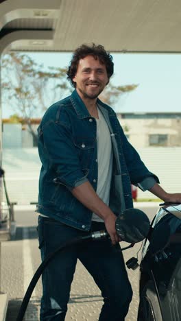 man filling up his car at a gas station