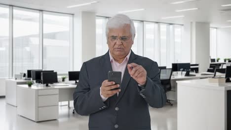 Indian-senior-manager-using-mobile-phone