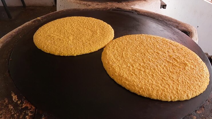 Cooking cachapas on a griddle in Zamuro, Venezuela’s Monagas state