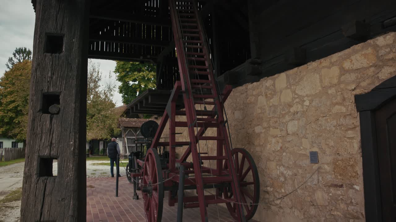Rustic wooden barn structure with ladder and stone base in Kumrovec, Croatia