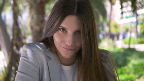 Portrait-Of-A-Beautiful-Young-Woman-Smiling-And-Looking-At-Camera-Outdoors