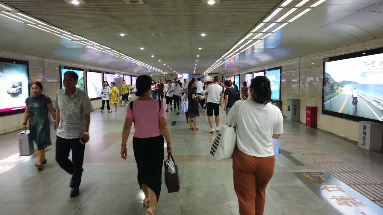 Xian, China -  July 2019 : People in the underground passage to the tube station