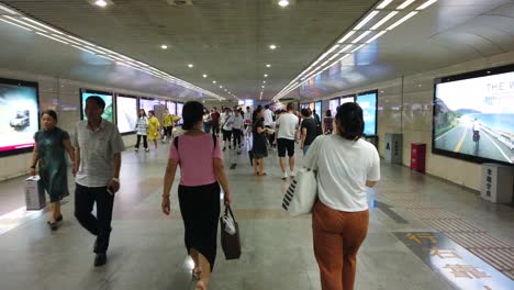 xian, china -  july 2019 : people in the underground passage to the tube station
