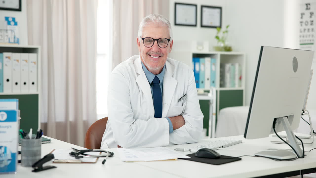 Smiling Senior Doctor Sitting at Desk in Medical Office