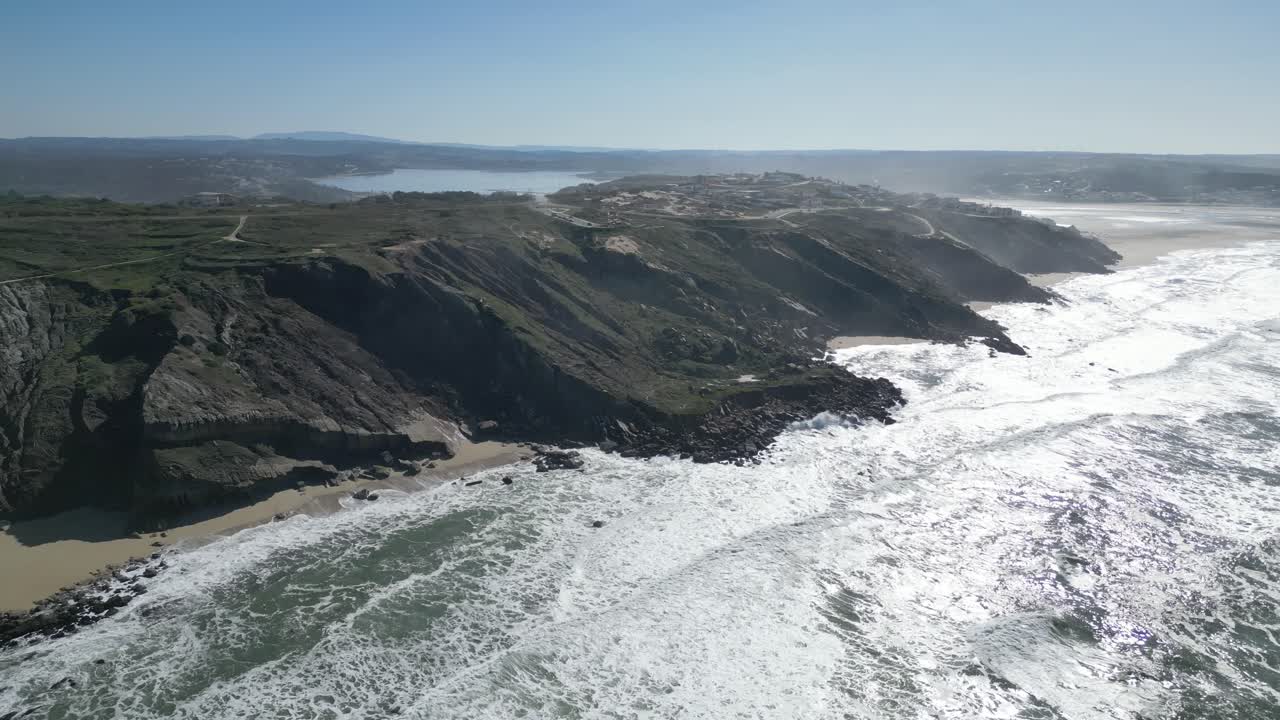 Majestic ocean cliffs at Miradouro do Salgado in Nazaré, Portugal on a sunny day
