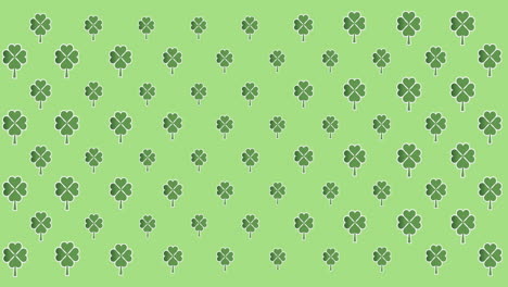 digital animation of multiple clover leaves moving against green background