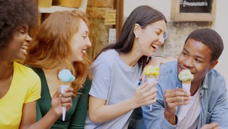 diverse group of happy friends enjoying ice cream together