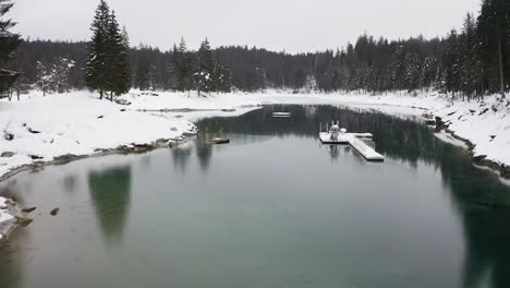 Aerial-flying-through-Caumalake-during-winter-season,-Flims---Switzerland