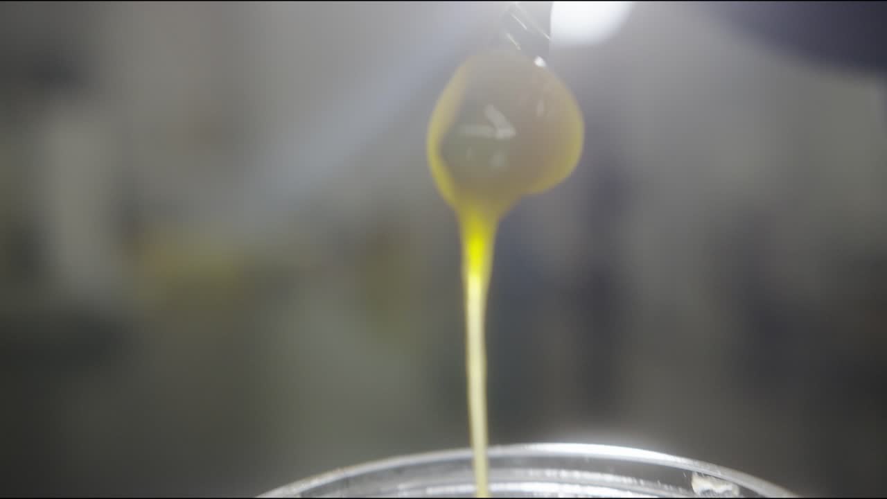 Scooping up spoonful of marijuana biomass extract