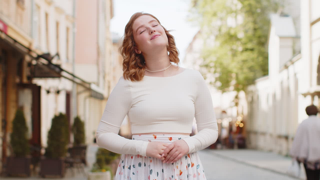 Thoughtful smiling woman with pensive expression pondering a solution thinking inspiration dreaming