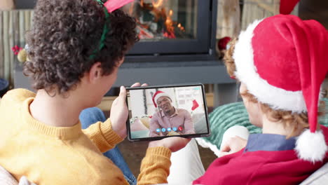 Happy-diverse-male-friends-having-christmas-tablet-video-call,-slow-motion