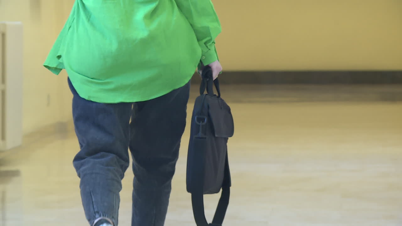 Person Walking Down a Hallway