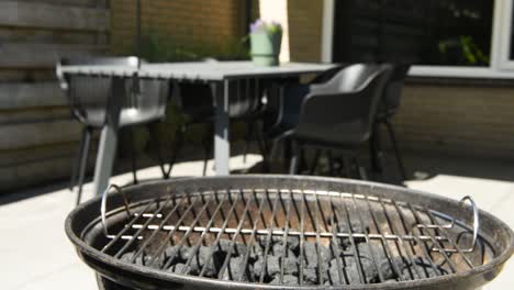 slowmotion zooming in shot of a barbecue bbq in a backyard