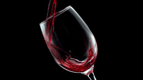 red wine pouring and swirling in crystal wineglass in slow motion on the black background