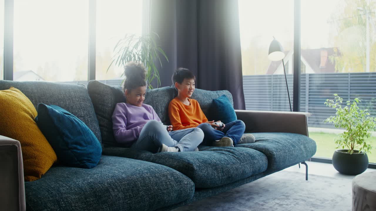 Children playing video games on the couch