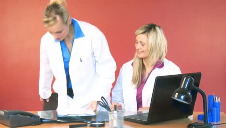 Female-doctor-leaving-the-office-and-shaking-hands-with-her-colleague