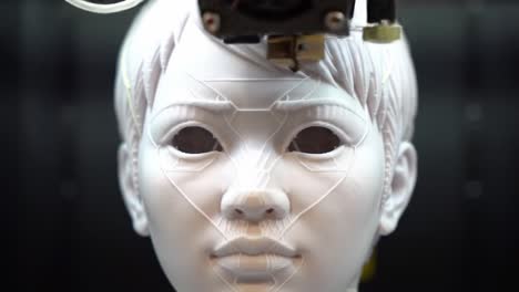 a cutting-edge 3d printing process captures the intricate details of a robotic face, showcasing the future of artificial intelligence technology and human-like features