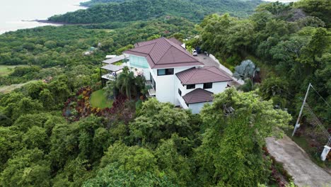 large white house on secluded tropical mountain top, costa rica drone