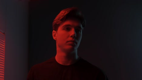 young man in red and blue light portrait