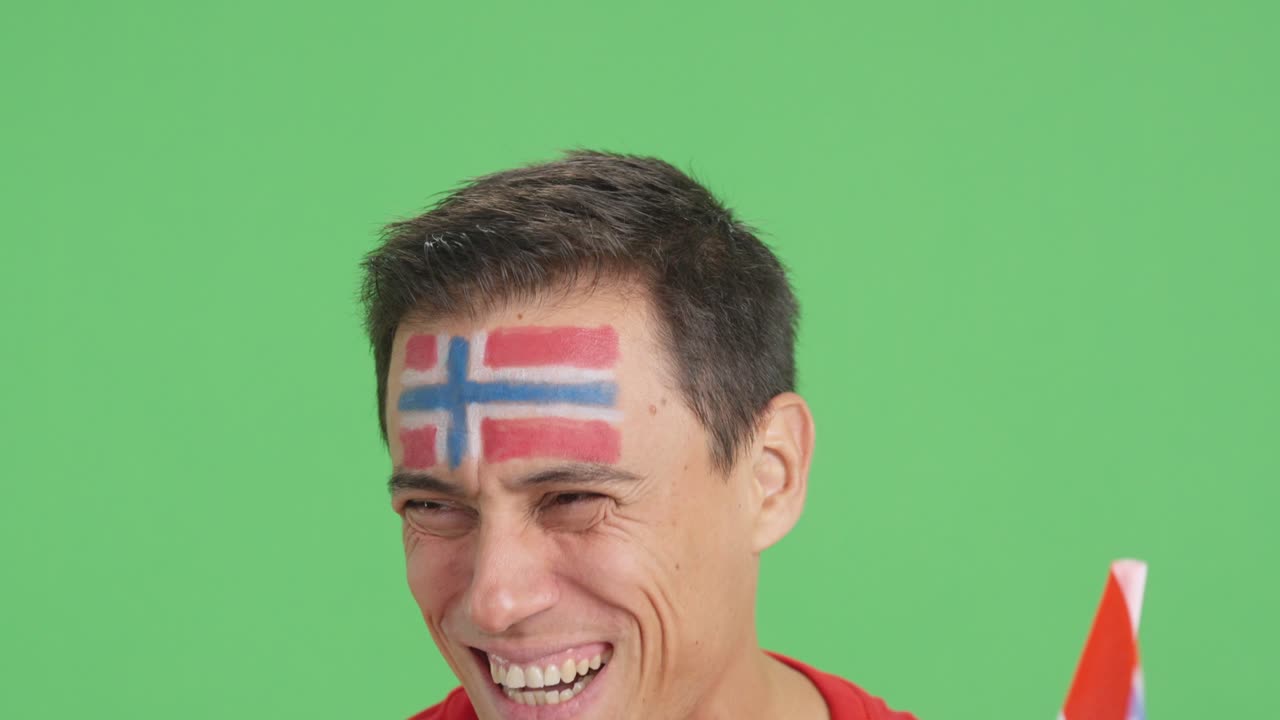 Close up of a man supporting norwegian team