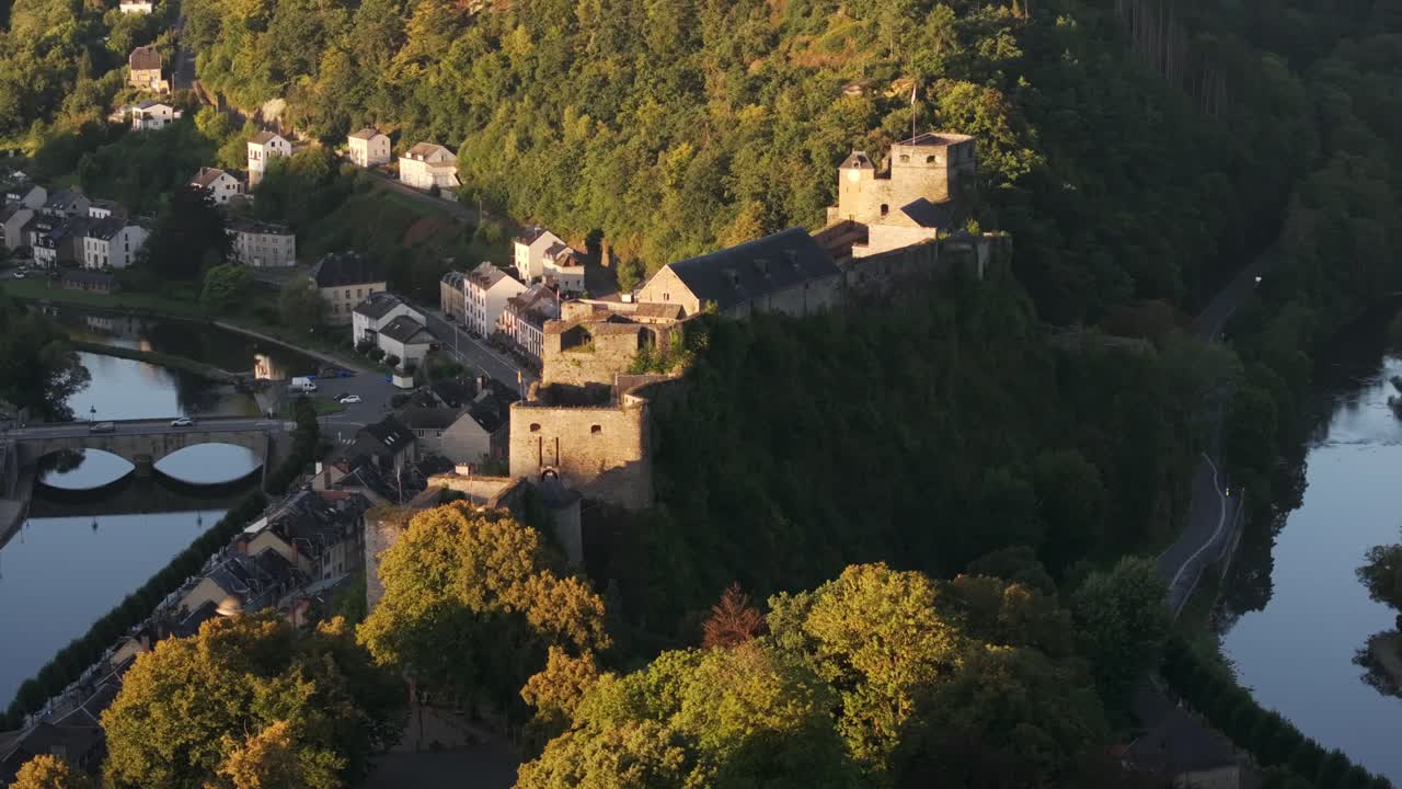Aerial view of a castle and village by a river