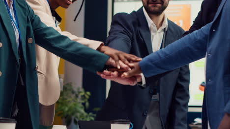 startup team uniting hands together to celebrate successful project