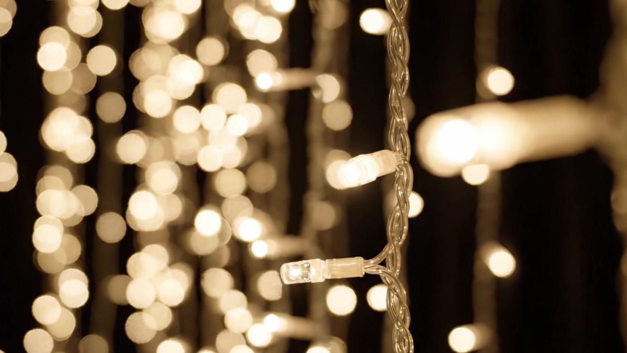Sparkling Holiday Ambiance: A Close-Up Exploration of Glittering String Lights Creating a Warm and Inviting Atmosphere for Festive Decor and Celebrations