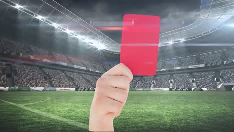 Animation-of-hand-holding-red-card-over-stadium