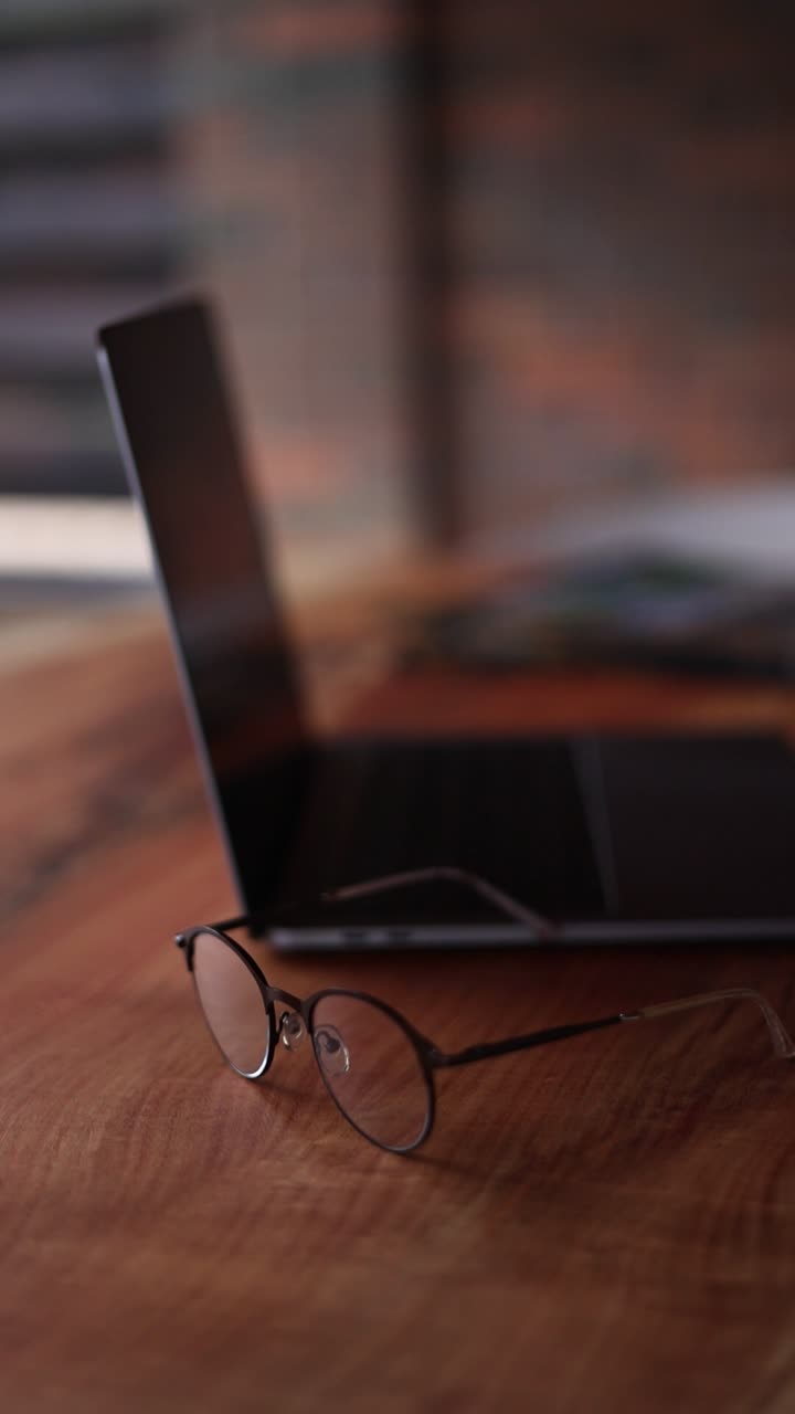Laptop and Glasses on a Wooden Table