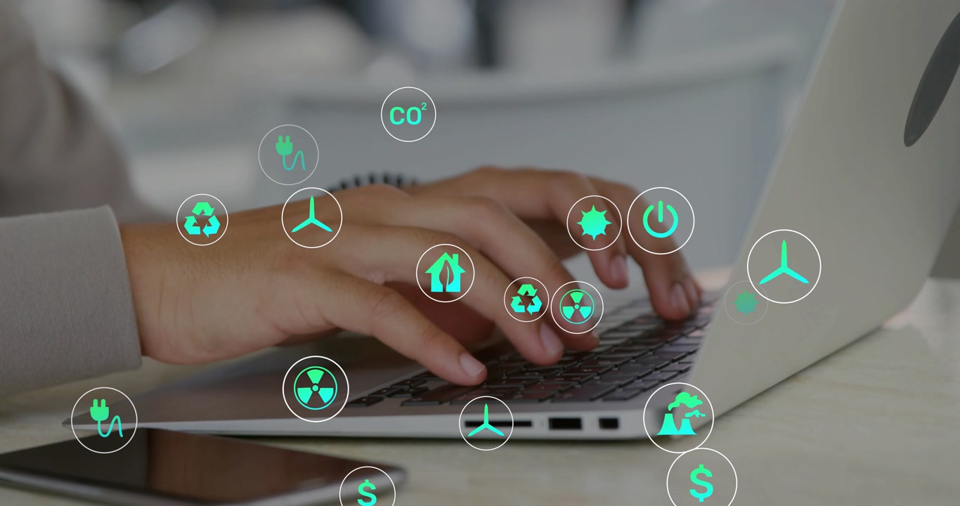 Male hands typing on laptop, icon popping near phone, icons rising across keys showing energy data