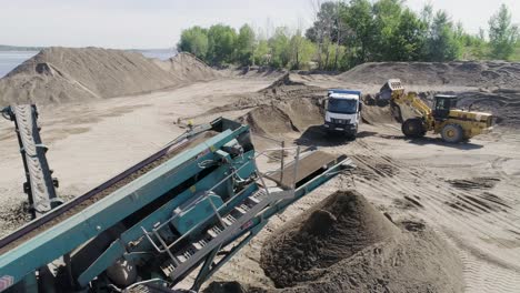 sand and gravel processing site with heavy equipment