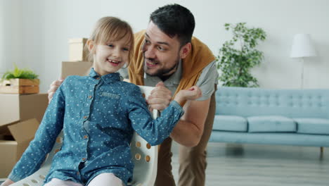 father and daughter playing in new home